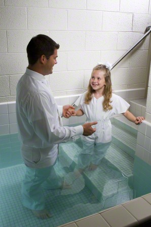 A child getting ready to be baptized under water